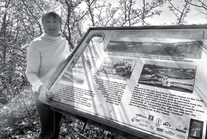 Anne Patrick with one of the interpretive signs on the St. Margaret’s Bay Trail